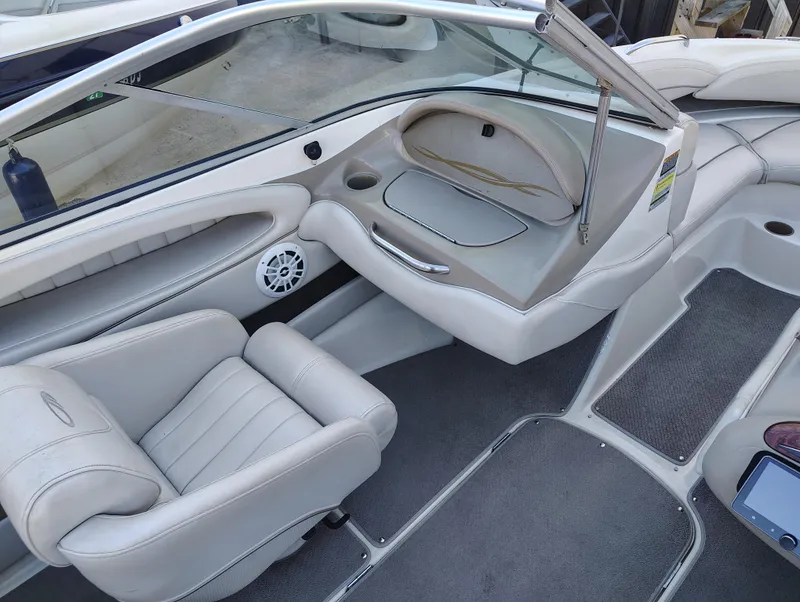 Slide: The Image of 2000 Maxum 1900 SR boat interior with beige seating and dashboard. - 4