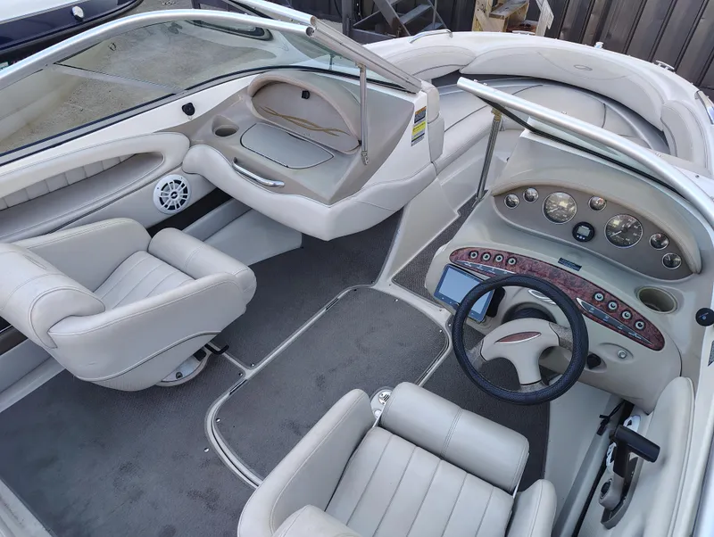 Slide: The Image of 2000 Maxum 1900 SR boat interior with white seating and dashboard controls. - 5