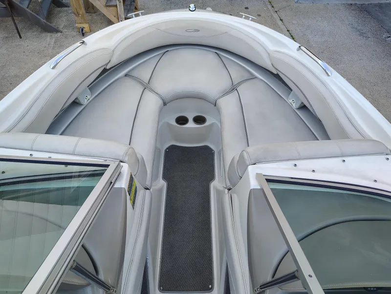 Slide: The Image of 2000 Maxum 1900 SR boat interior with gray seating and cup holders. - 9