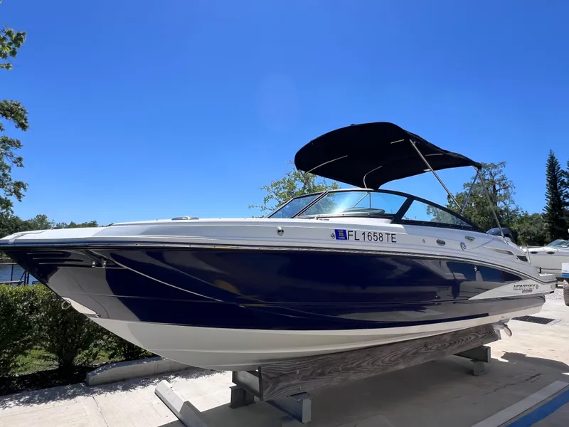 Slide: The Image of 2022 Monterey M45 boat with 250 Verado engine, blue hull, on display under clear sky. - 2