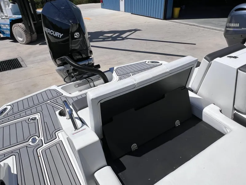 Slide: The Image of 2022 Monterey M45 boat with Mercury 250 Verado engine, docked, showing seating and deck details. - 20