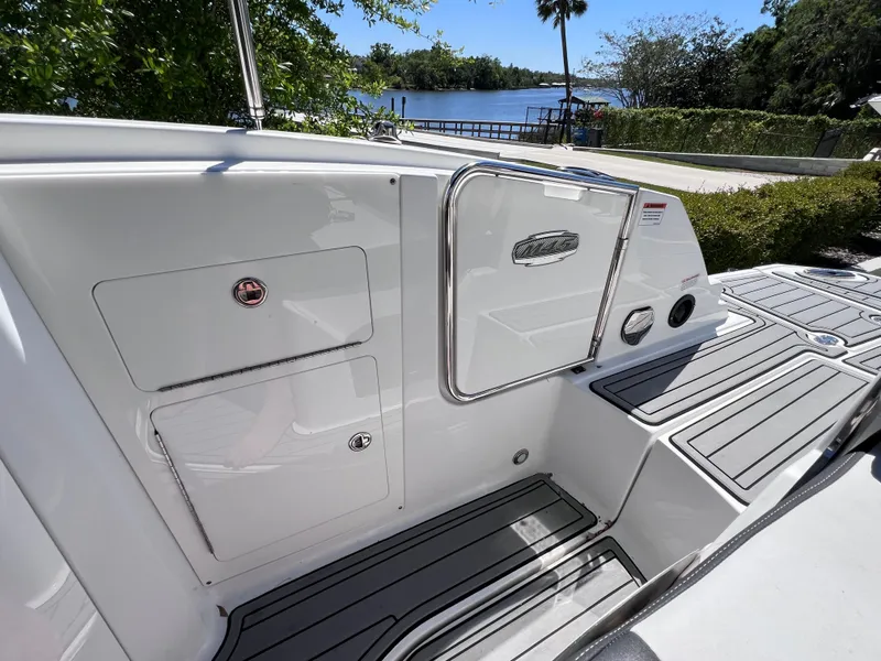 Slide: The Image of 2022 Monterey M45 boat deck with storage compartments, near a scenic waterfront. - 27