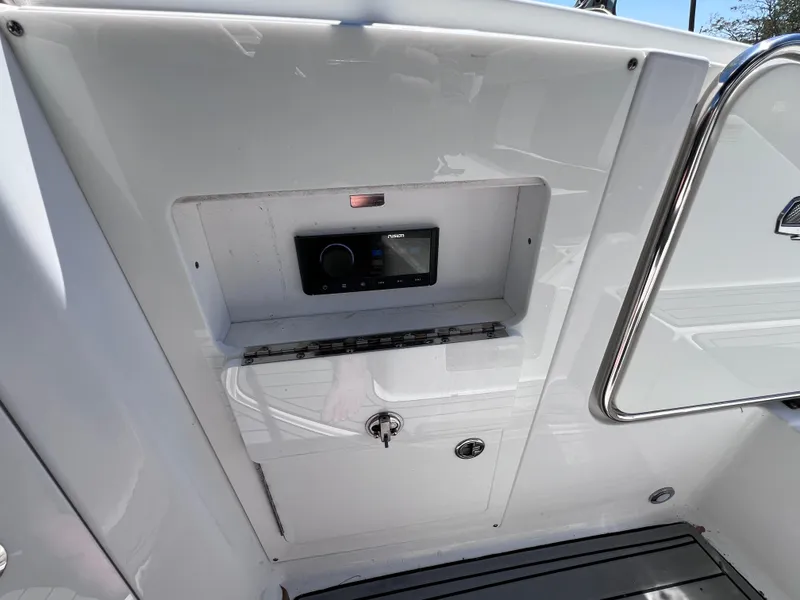 Slide: The Image of 2022 Monterey M45 boat control panel with sleek white finish and secure lock. - 29