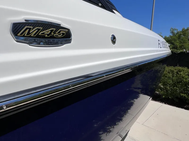 Slide: The Image of 2022 Monterey M45 boat with 250 Verado engine, side view, blue and white exterior. - 5
