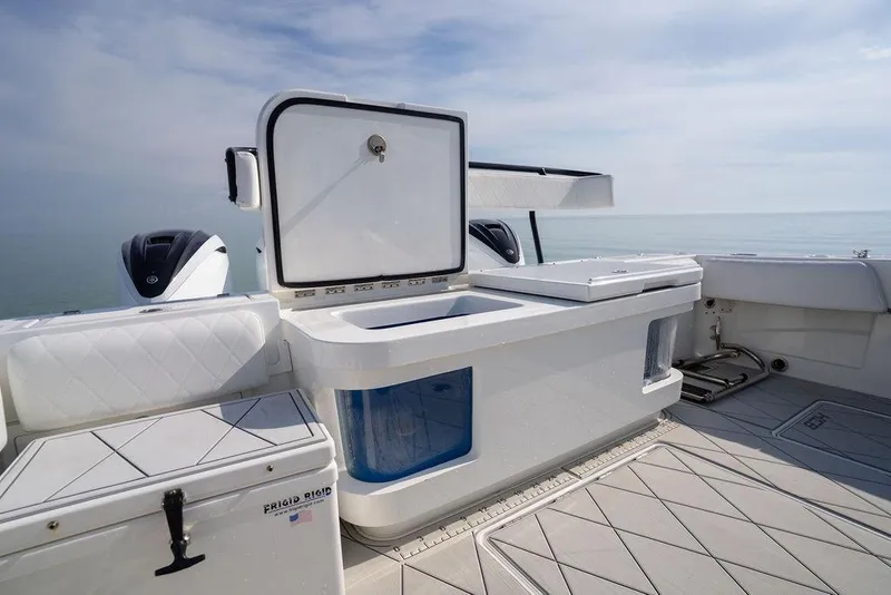 Slide: The Image of 2019 HCB 53 boat deck with storage compartments and ocean view. - 10