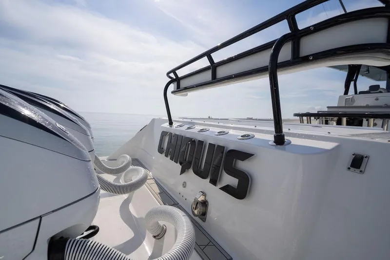 Slide: The Image of 2019 HCB 53 boat with engines, sleek design, and open sea view. - 11