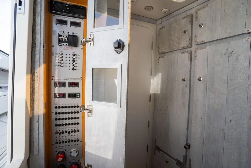 Slide: The Image of 2019 HCB 53 boat cruising on calm, clear waters under a cloudy sky. - 14