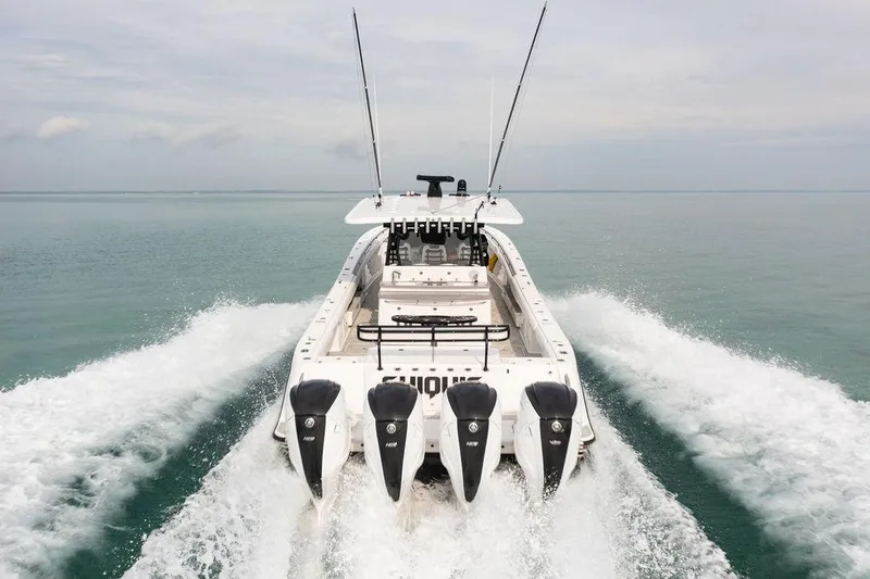 Slide: The Image of 2019 HCB 53 boat with four engines cruising on open water. - 19