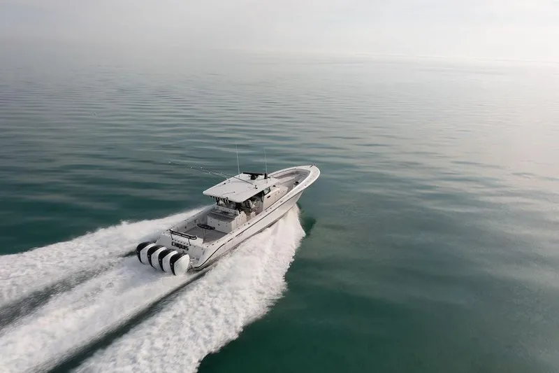 Slide: The Image of Aerial view of 2019 HCB 53 boat on clear turquoise water. - 2