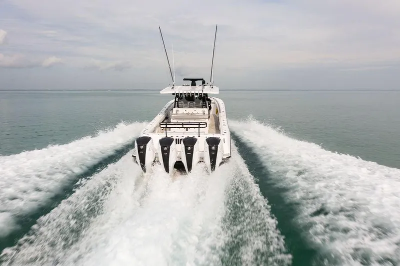 Slide: The Image of 2019 HCB 53 boat speeding on open water, leaving a wake behind. - 20