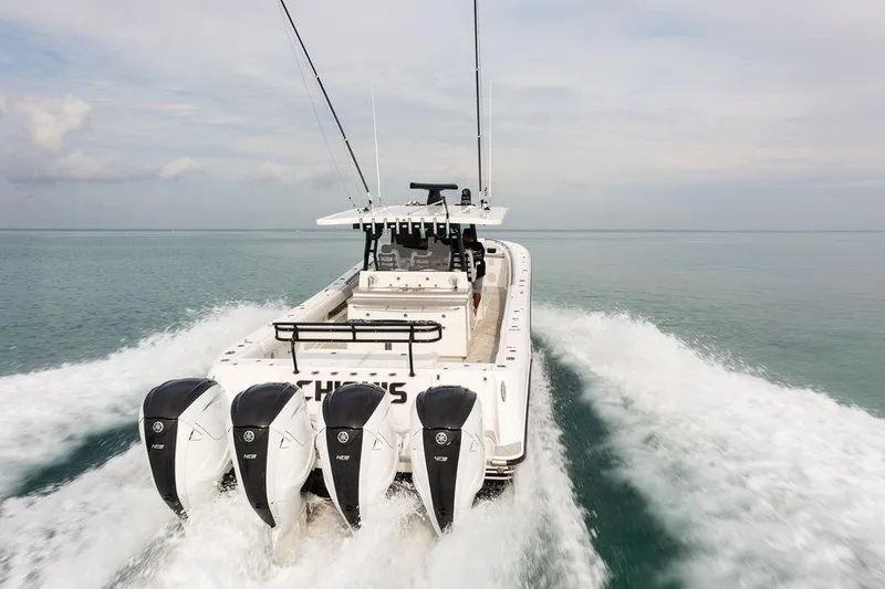 Slide: The Image of 2019 HCB 53 boat with four engines cruising on open water. - 21