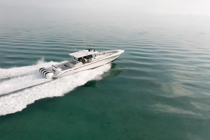 Slide: The Image of 2019 HCB 53 boat cruising on calm, clear water. - 3
