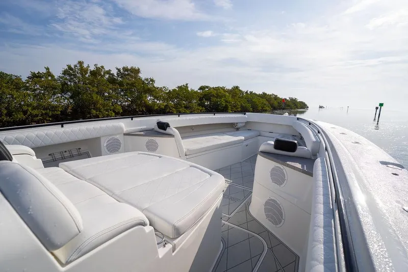 Slide: The Image of Luxurious 2019 HCB 53 boat interior with white seating, set against a serene water backdrop. - 31