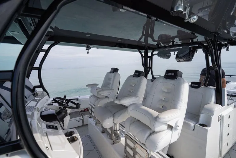 Slide: The Image of Luxurious 2019 HCB 53 boat interior with plush white seating and modern controls. - 35