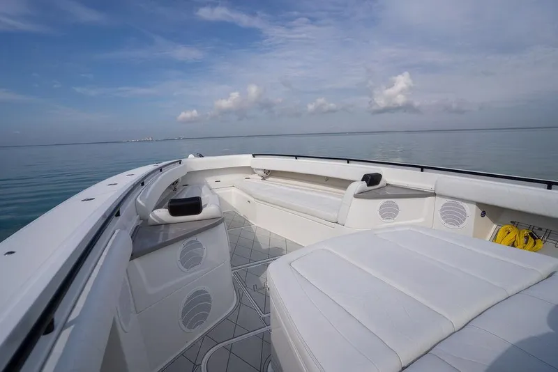 Slide: The Image of 2019 HCB 53 boat interior with white seating, open sea view, and clear sky. - 36