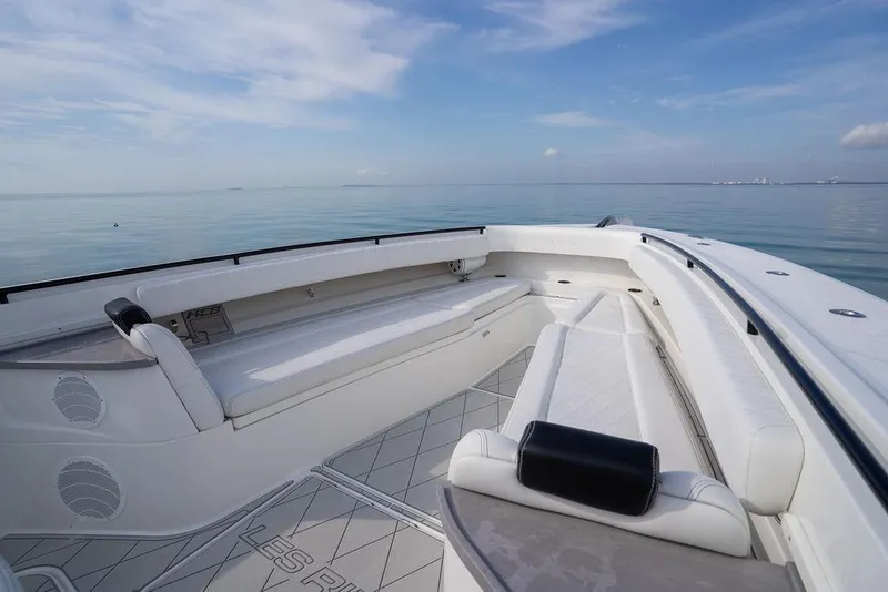 Slide: The Image of 2019 HCB 53 boat interior with white seating, calm ocean view. - 37