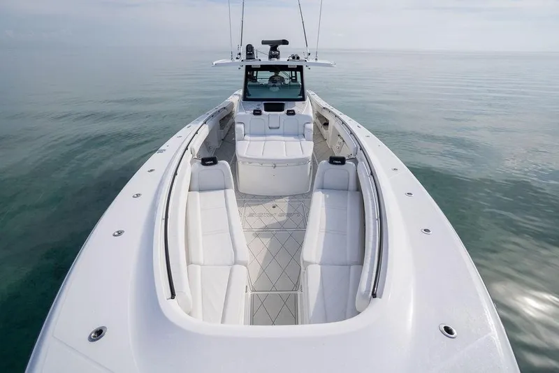 Slide: The Image of 2019 HCB 53 boat with spacious seating on calm water. - 41