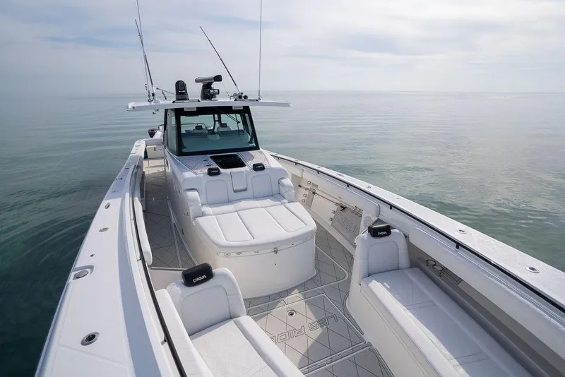 Slide: The Image of 2019 HCB 53 boat with spacious deck and seating on calm water. - 43