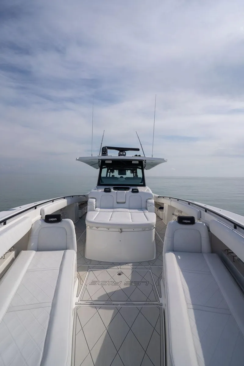 Slide: The Image of 2019 HCB 53 boat cruising on calm water, side view. - 6