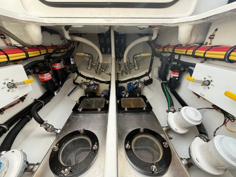 Slide: The Image of Engine compartment of a 2016 Nor-Tech 392 Super Fish Center Console, showcasing detailed mechanical components. - 19
