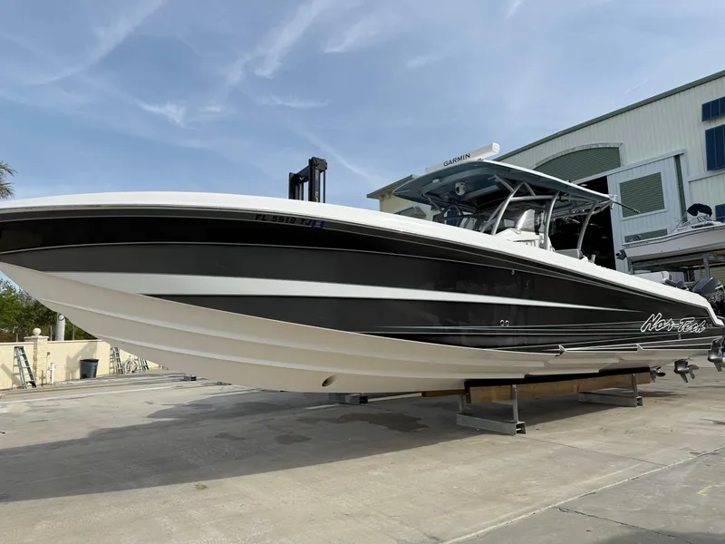 Slide: The Image of 2016 Nor-Tech 392 Super Fish Center Console boat on display, black and white design. - 2