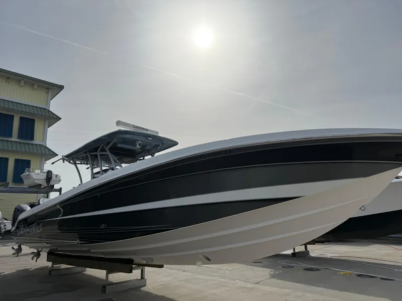 Slide: The Image of 2016 Nor-Tech 392 Super Fish Center Console boat under a bright sun. - 3