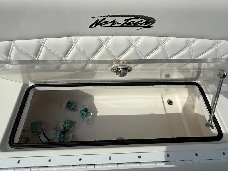 Slide: The Image of 2016 Nor-Tech 392 Super Fish Center Console storage compartment with water bottles. - 30