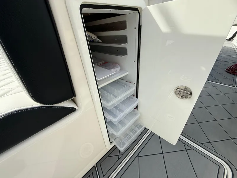 Slide: The Image of 2016 Nor-Tech 392 Super Fish Center Console storage compartment with organized tackle boxes. - 31