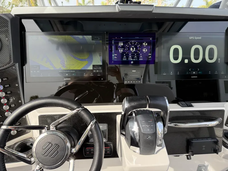 Slide: The Image of Dashboard of 2016 Nor-Tech 392 Super Fish Center Console with navigation displays. - 37