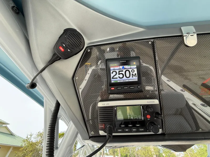 Slide: The Image of 2016 Nor-Tech 392 Super Fish Center Console dashboard with marine radio and navigation display. - 44