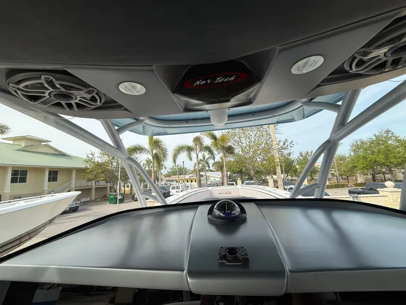 Slide: The Image of 2016 Nor-Tech 392 Super Fish Center Console boat interior with dashboard and speakers. - 46