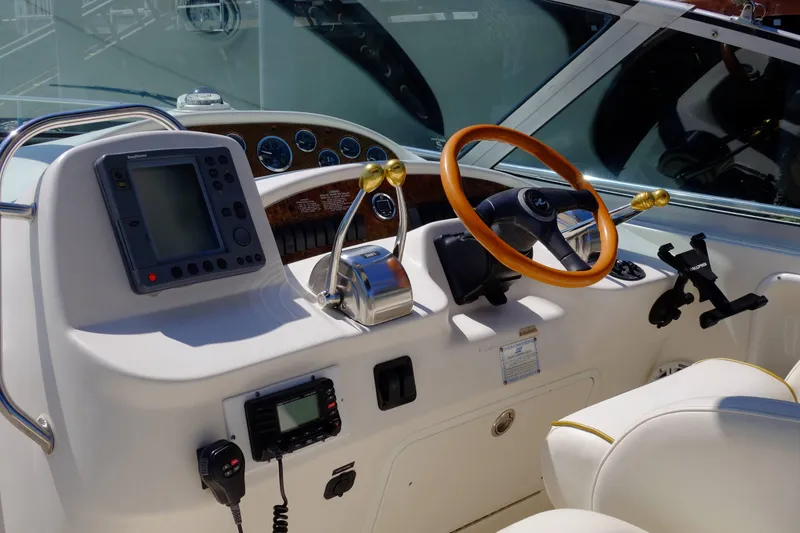 Slide: The Image of Cockpit of 2000 Sea Ray 340 Sundancer with steering wheel and navigation equipment. - 12