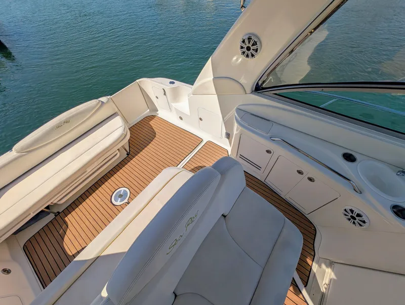 Slide: The Image of 2000 Sea Ray 340 Sundancer boat interior with white seating and teak flooring. - 14