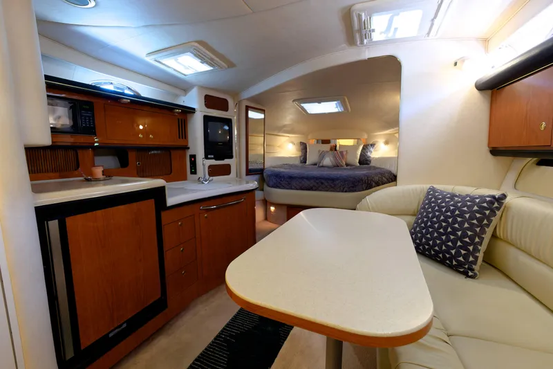 Slide: The Image of Interior of 2000 Sea Ray 340 Sundancer yacht with kitchen, seating, and sleeping area. - 15