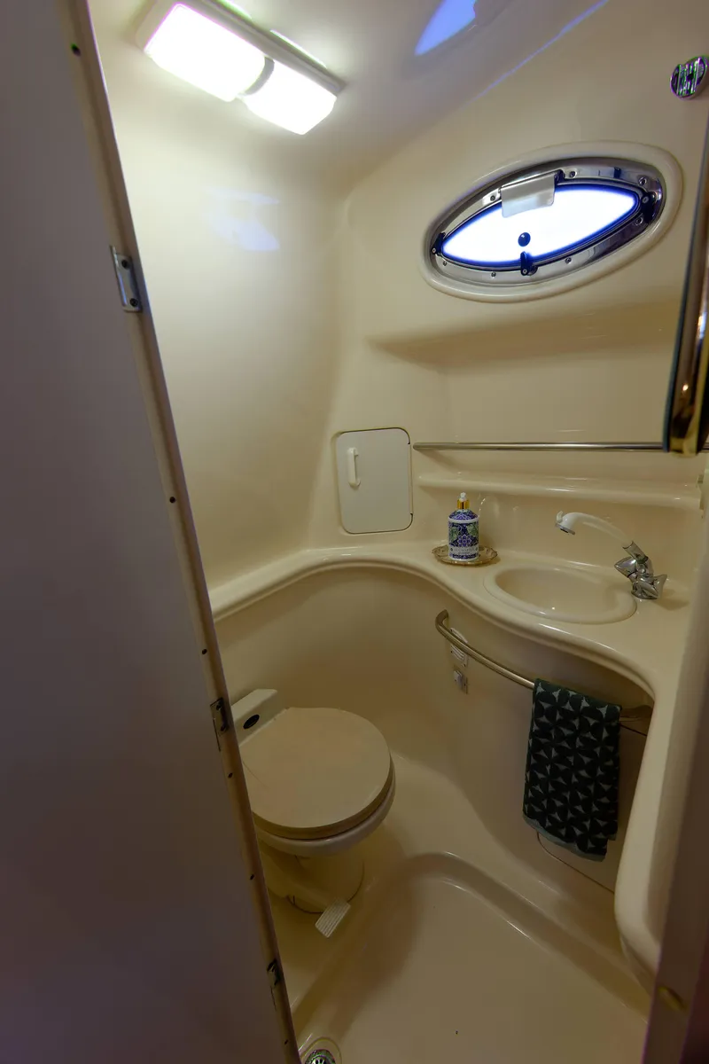 Slide: The Image of Bathroom interior of 2000 Sea Ray 340 Sundancer yacht, featuring sink and porthole. - 26