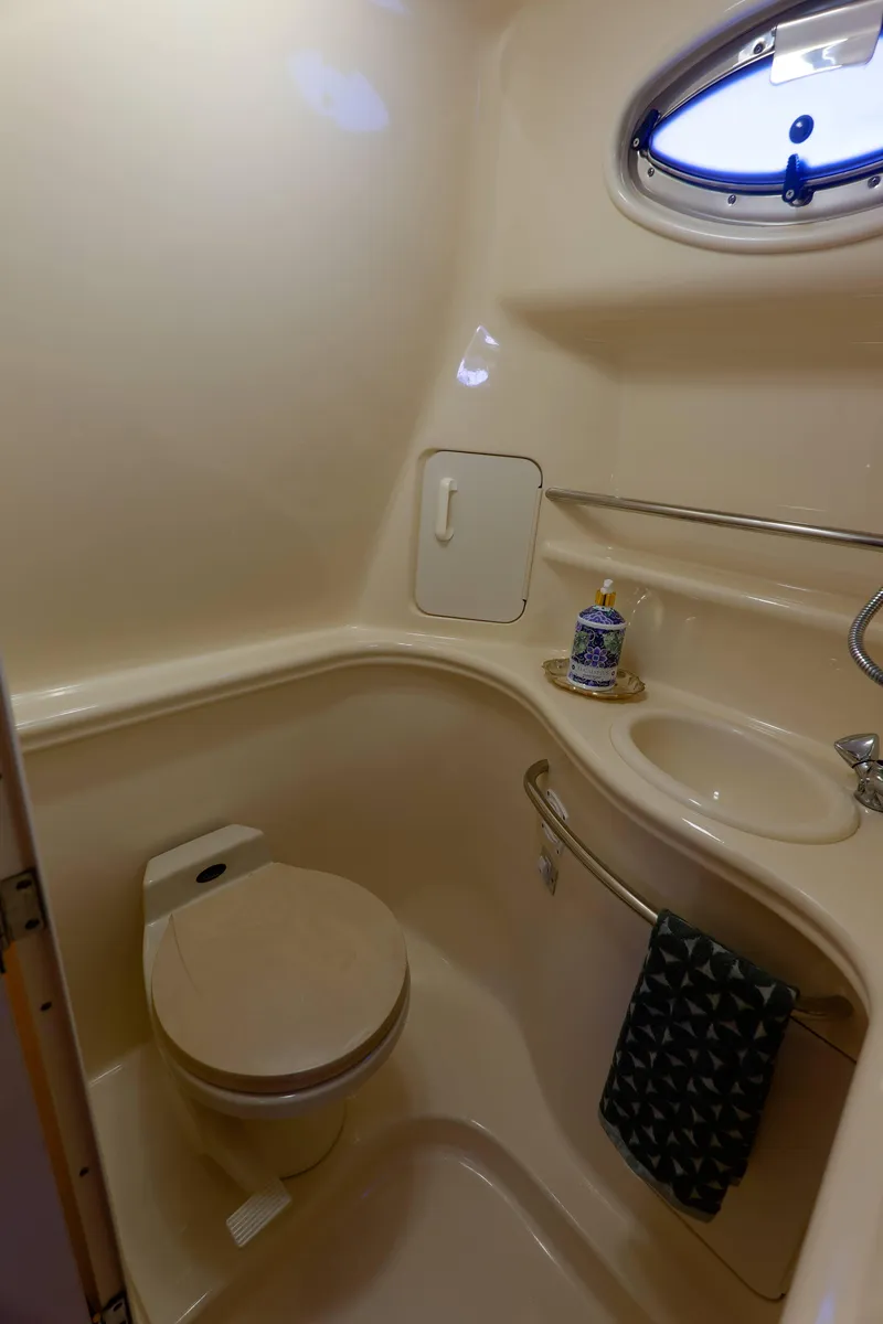 Slide: The Image of Compact bathroom in a 2000 Sea Ray 340 Sundancer yacht with toilet and sink. - 28