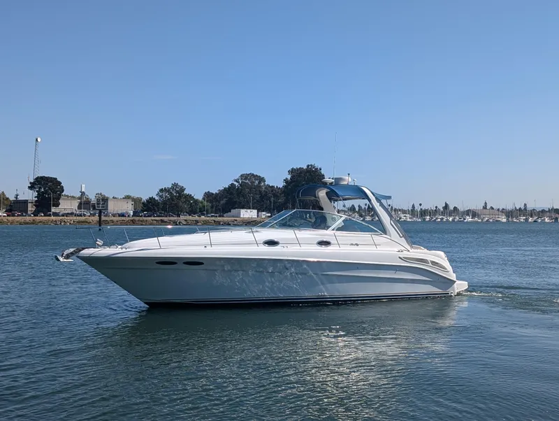 Slide: The Image of 2000 Sea Ray 340 Sundancer cruising on calm waters under a clear blue sky. - 33