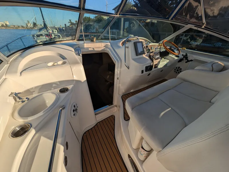 Slide: The Image of Interior view of 2000 Sea Ray 340 Sundancer yacht cockpit with seating and controls. - 38