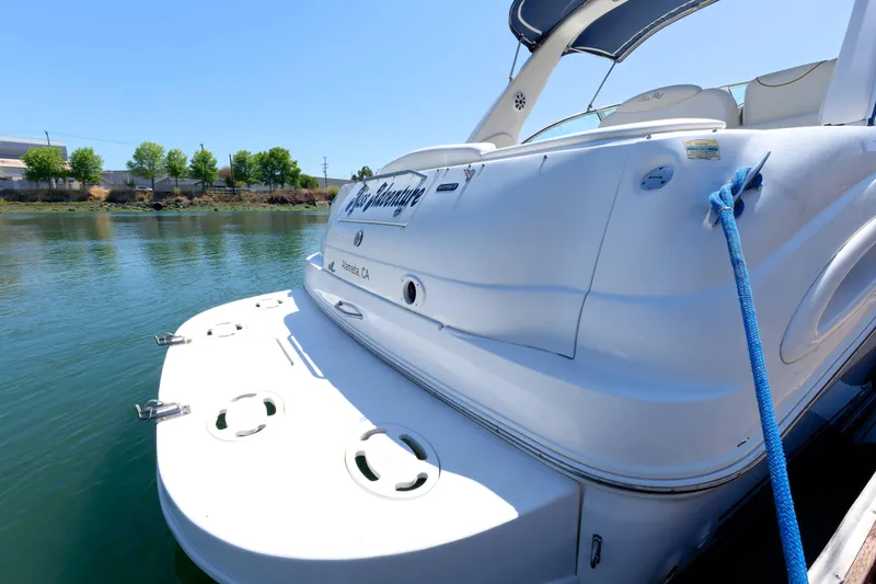 Slide: The Image of 2000 Sea Ray 340 Sundancer docked on a sunny day, rear view. - 4