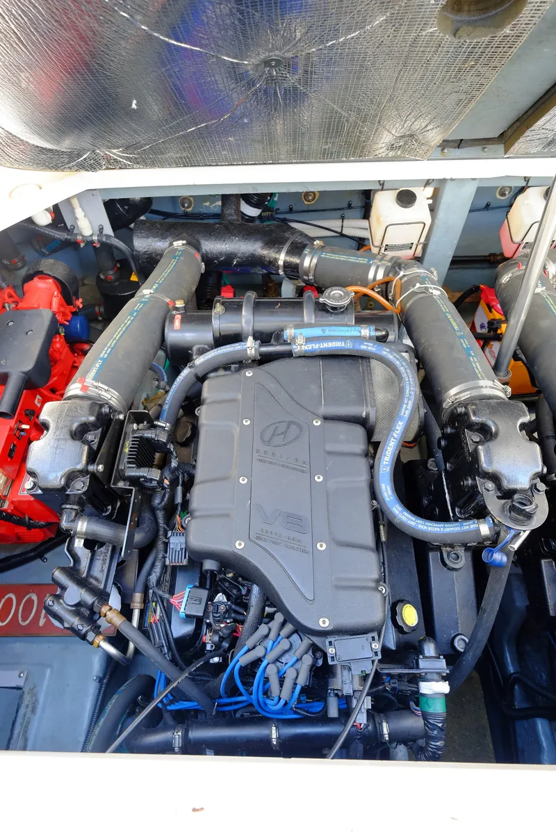 Slide: The Image of Engine compartment of a 2000 Sea Ray 340 Sundancer boat, showcasing detailed mechanical components. - 41