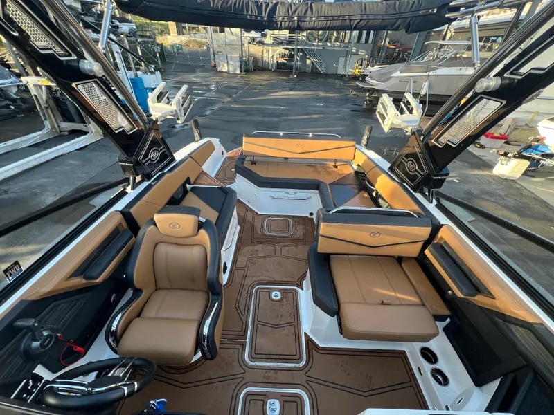 Slide: The Image of 2023 Cobalt R6 Surf boat interior with tan seating and modern design. - 13