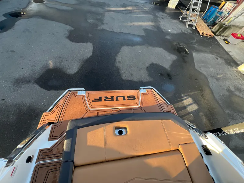 Slide: The Image of 2023 Cobalt R6 Surf boat with brown deck and "SURF" logo, viewed from above. - 15