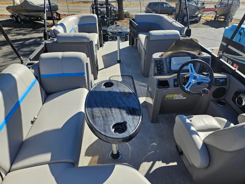 Slide: The Image of 2022 Apex Marine Qwest E CLASS 822 XRE TRITUNE interior with seating and steering console. - 10