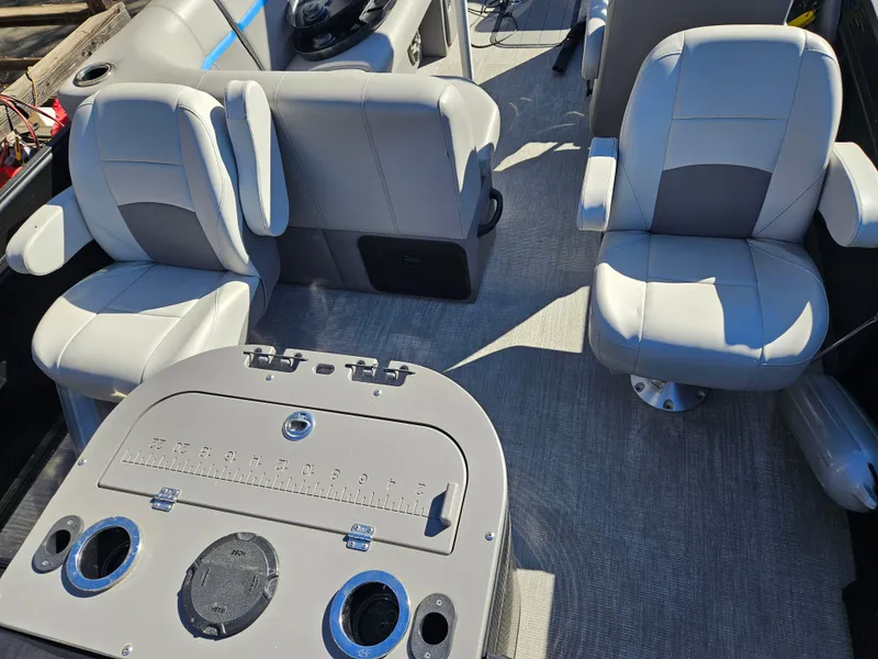 Slide: The Image of 2022 Apex Marine Qwest E CLASS 822 XRE TRITUNE interior with seating and console. - 12