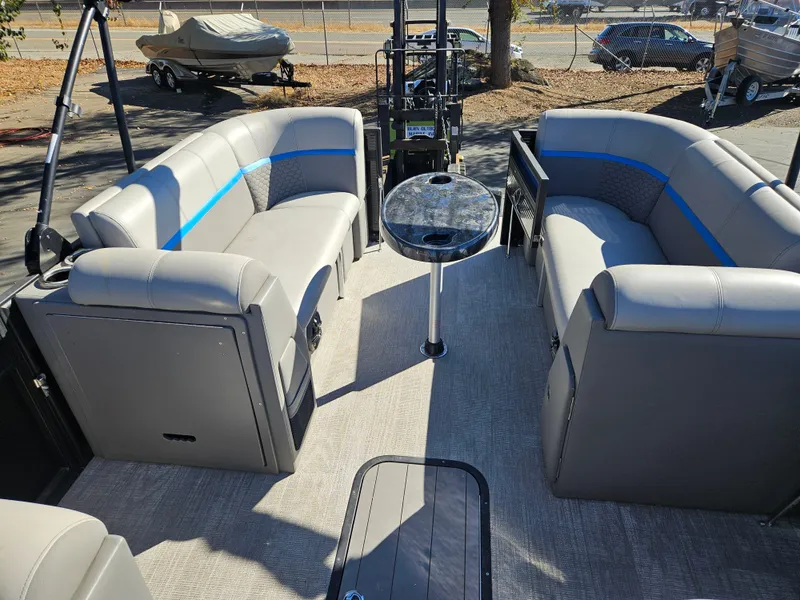 Slide: The Image of 2022 Apex Marine Qwest E CLASS 822 XRE TRITUNE interior with gray seating and central table. - 18