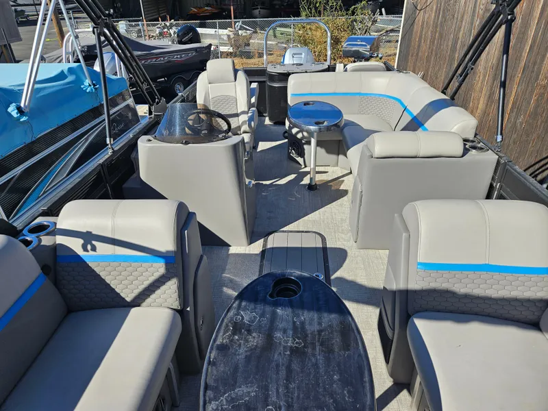 Slide: The Image of 2022 Apex Marine Qwest E CLASS 822 XRE TRITUNE interior with seating and steering console. - 19