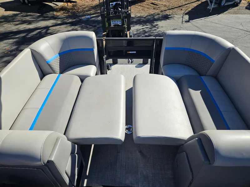 Slide: The Image of 2022 Apex Marine Qwest E CLASS 822 XRE TRITUNE interior with gray seating and blue accents. - 4