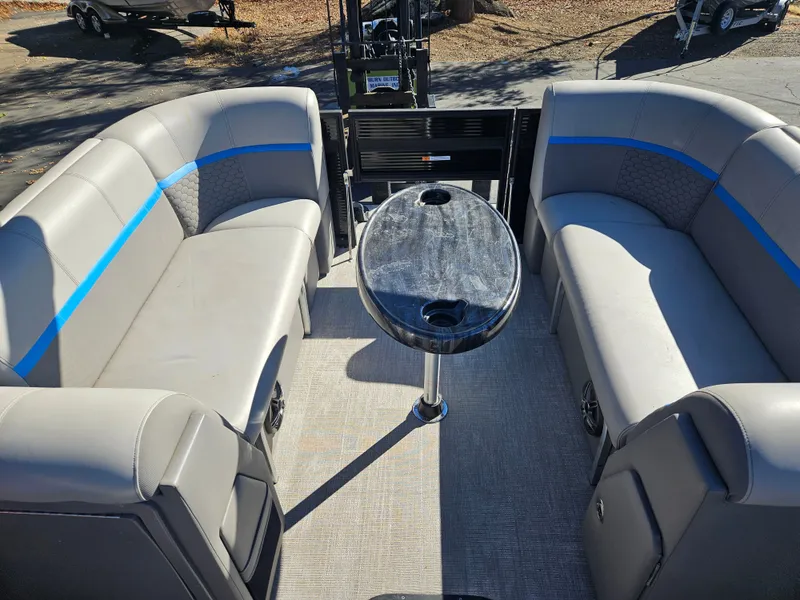 Slide: The Image of 2022 Apex Marine Qwest E CLASS 822 XRE TRITUNE interior with gray seating and table. - 5