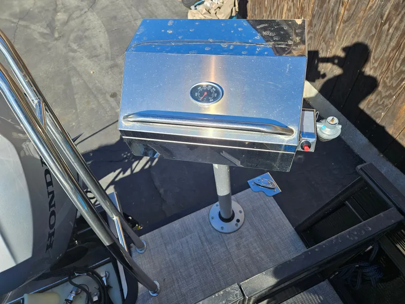 Slide: The Image of Stainless steel grill on 2022 Apex Marine Qwest E CLASS 822 XRE TRITUNE boat deck. - 8