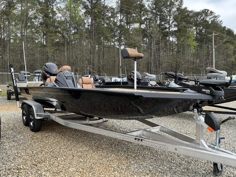 Slide: The Image of 2025 Xpress Hyper-Lift Bass Series boat on trailer, parked outdoors. - 1